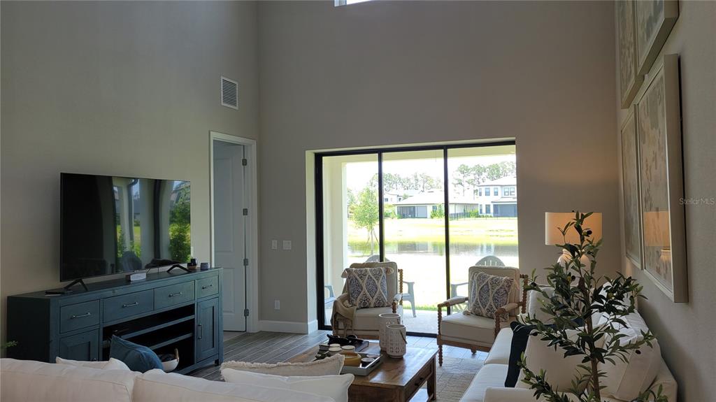 5419 Summit Glen Bradenton, FL 34203 - Photo 8 of 38 a living room with furniture a flat screen tv and a fireplace