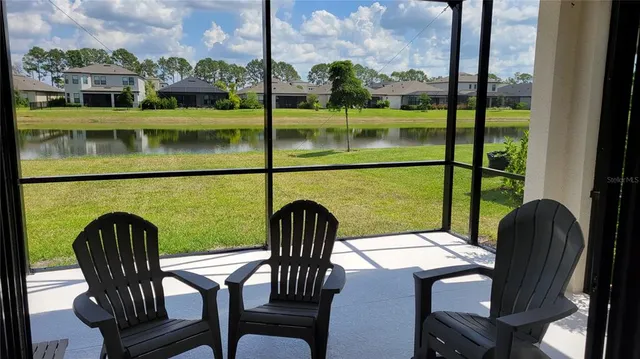a view of a chairs and table in a balcony