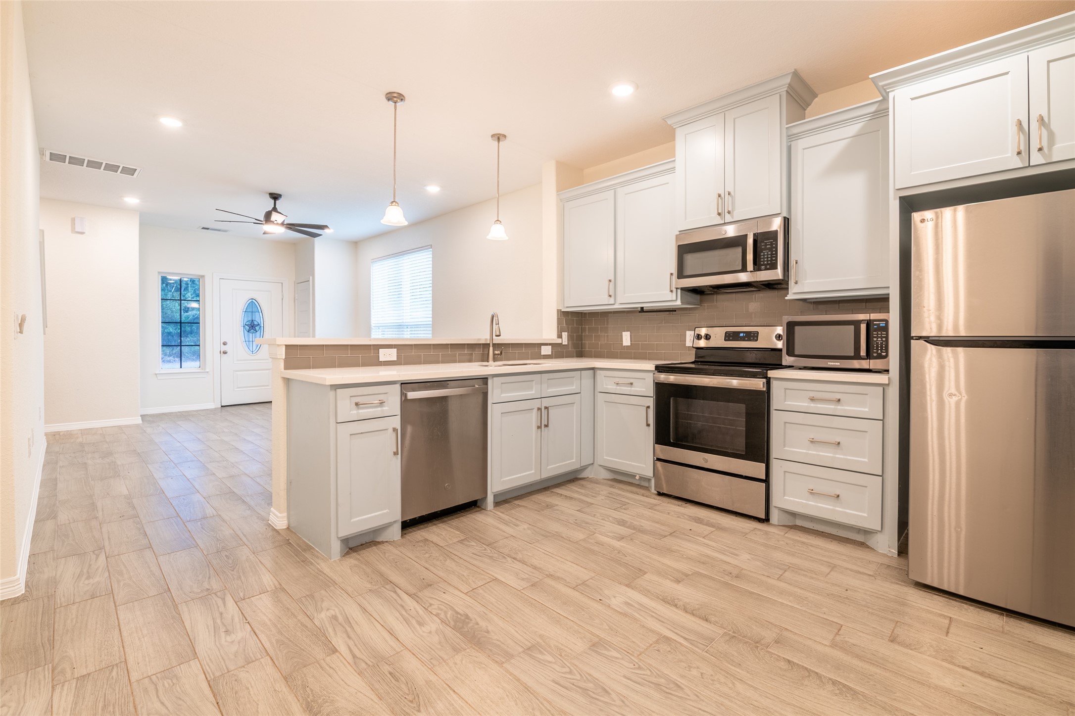 25012 Armagh Road Hempstead, TX 77445 - Photo 11 of 33 a kitchen with white cabinets and stainless steel appliances