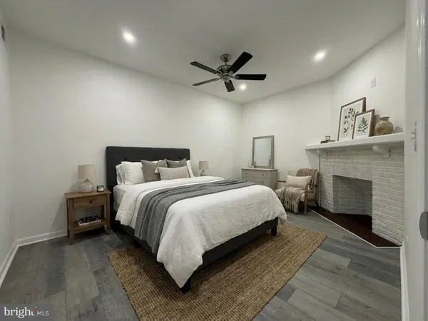 a bedroom with a bed and a fireplace