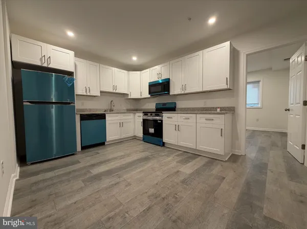 a kitchen with stainless steel appliances granite countertop a refrigerator sink and cabinets