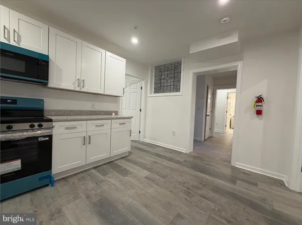 a view of a kitchen with electric appliances