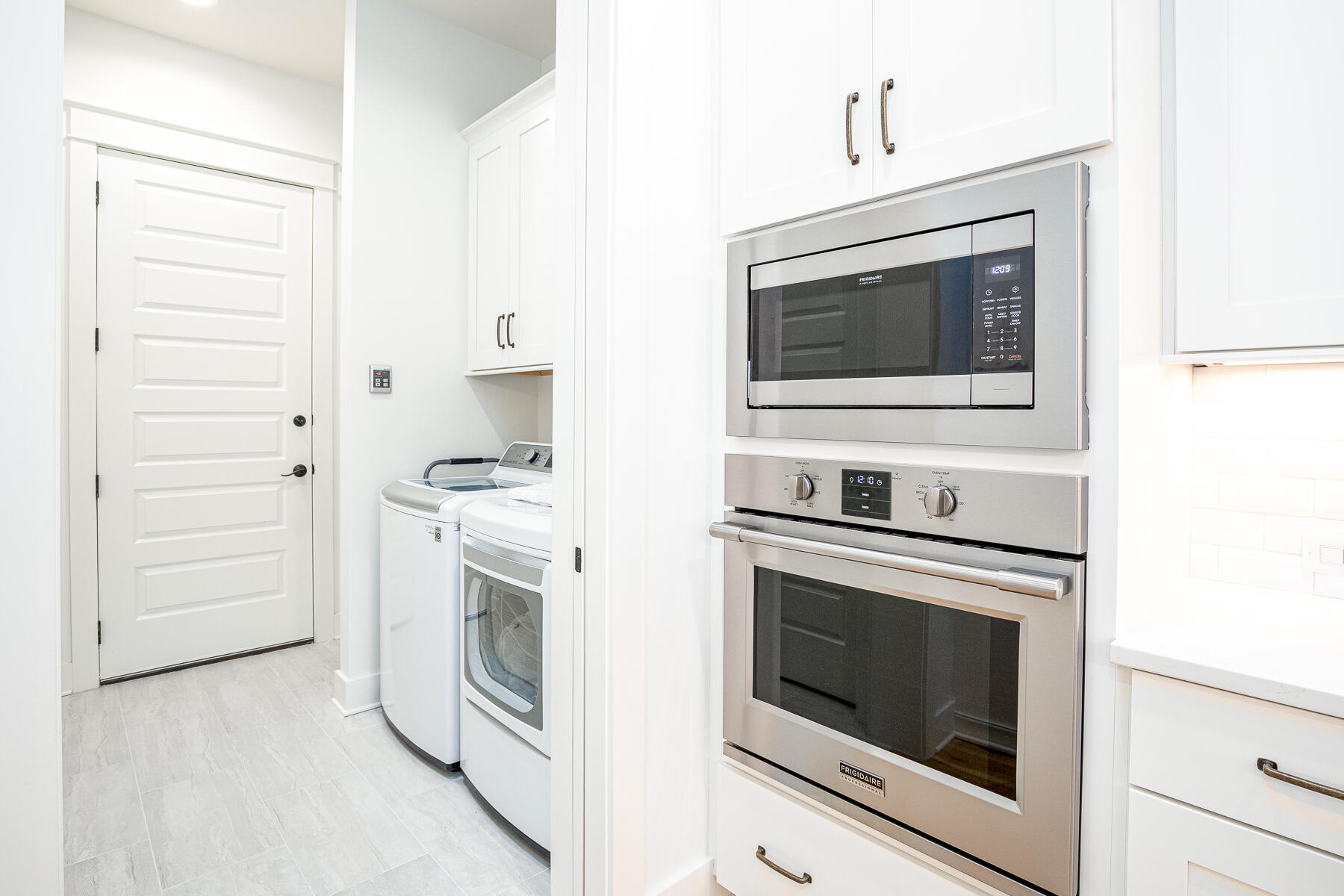 299 Ridgewalk Circle Santa Rosa Beach, FL 32459 - Photo 15 of 46 a kitchen with white cabinets and stainless steel appliances