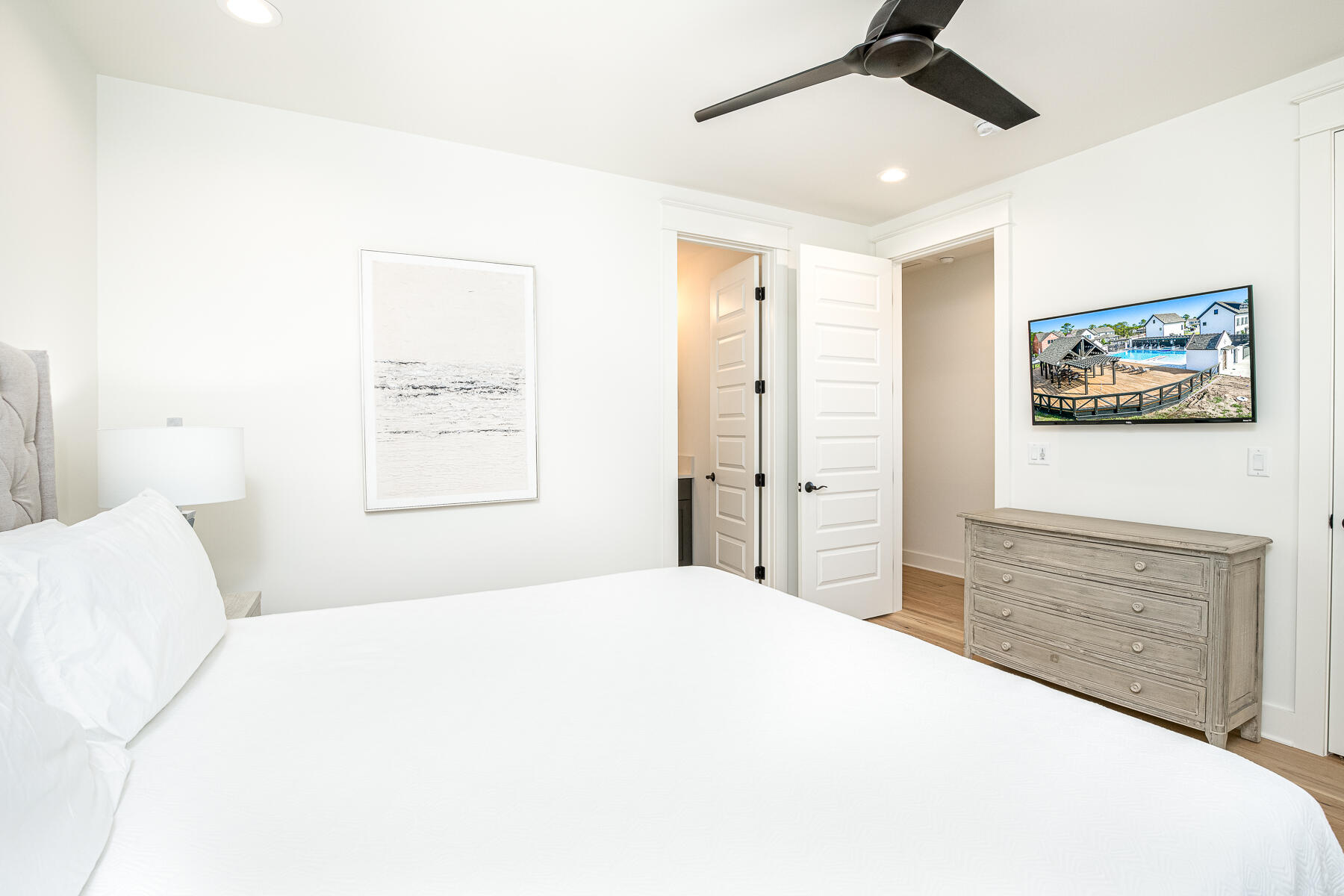 299 Ridgewalk Circle Santa Rosa Beach, FL 32459 - Photo 28 of 46 a bedroom with a large bed and a chandelier