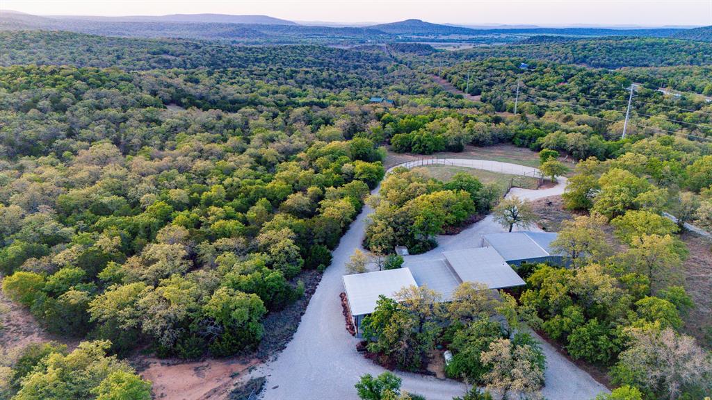 3257 Finis Road Graham, TX 76450 - Photo 2 of 40 an aerial view of green landscape with trees houses and mountain view