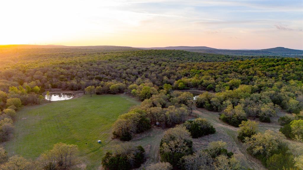 3257 Finis Road Graham, TX 76450 - Photo 4 of 40 a view of a lush green hillside and houses