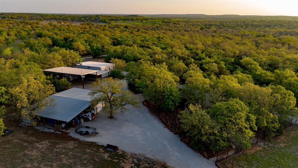 3257 Finis Road Graham, TX 76450 - Photo 6 of 40 a view of a terrace with a table and chairs under an umbrella