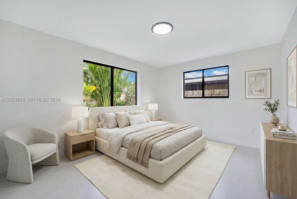 6566 Southwest 35th Street Miami, FL 33155 - Photo 16 of 36 a bedroom with a bed and a couch