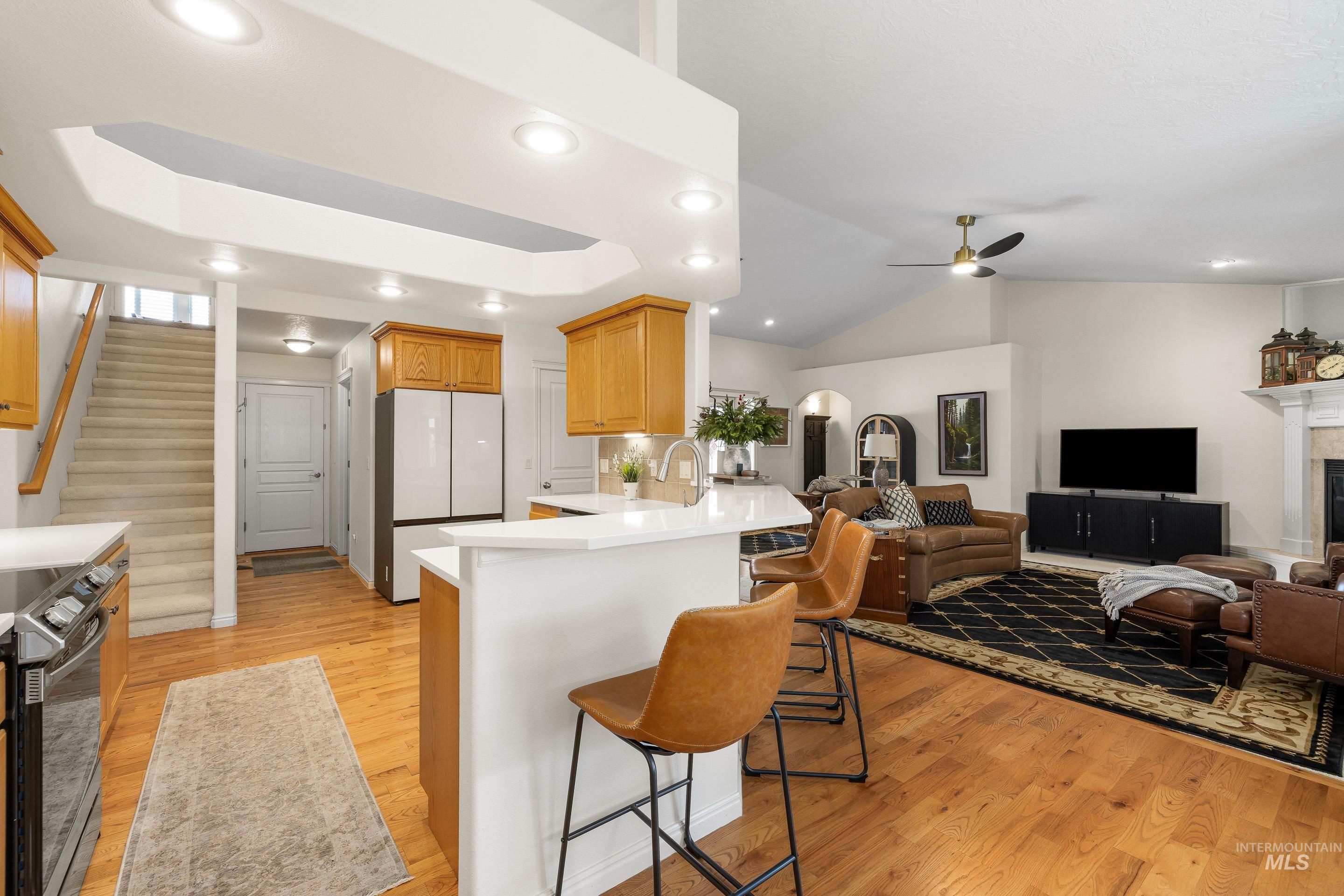 3631 North Alexis Way Meridian, ID 83646 - Photo 49 of 49 Kitchen with open floor plan, range with electric cooktop, a kitchen bar, freestanding refrigerator, and a peninsula