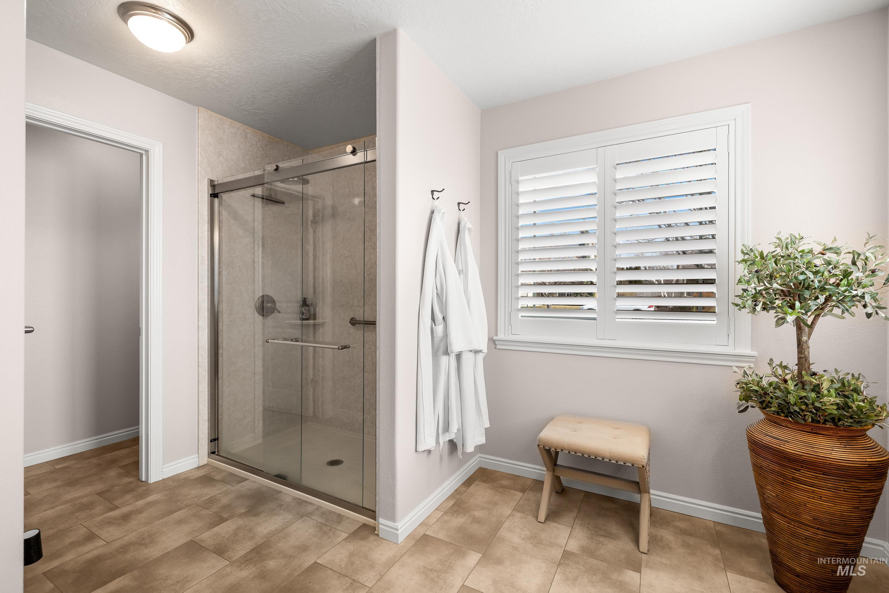 3631 North Alexis Way Meridian, ID 83646 - Photo 32 of 49 Full bathroom featuring a shower stall and baseboards