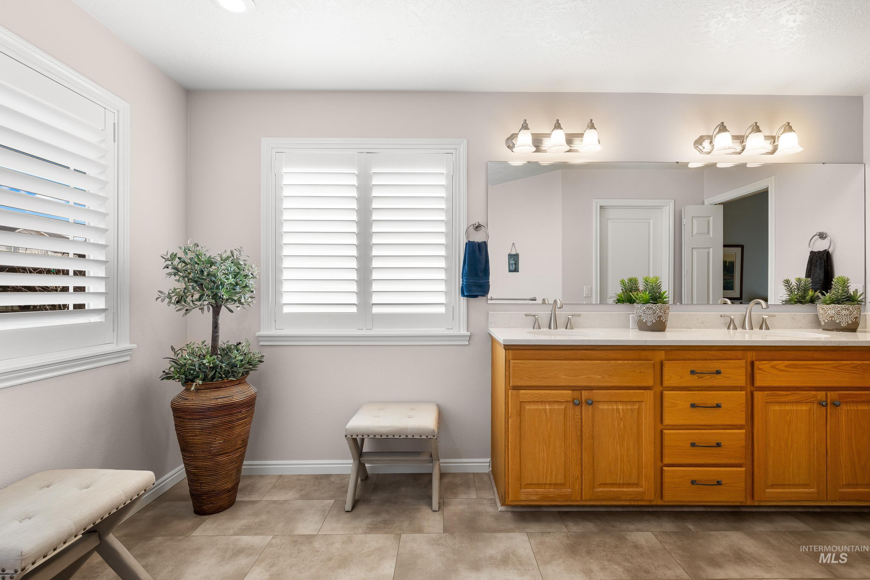 3631 North Alexis Way Meridian, ID 83646 - Photo 33 of 49 Full bath with double vanity and baseboards