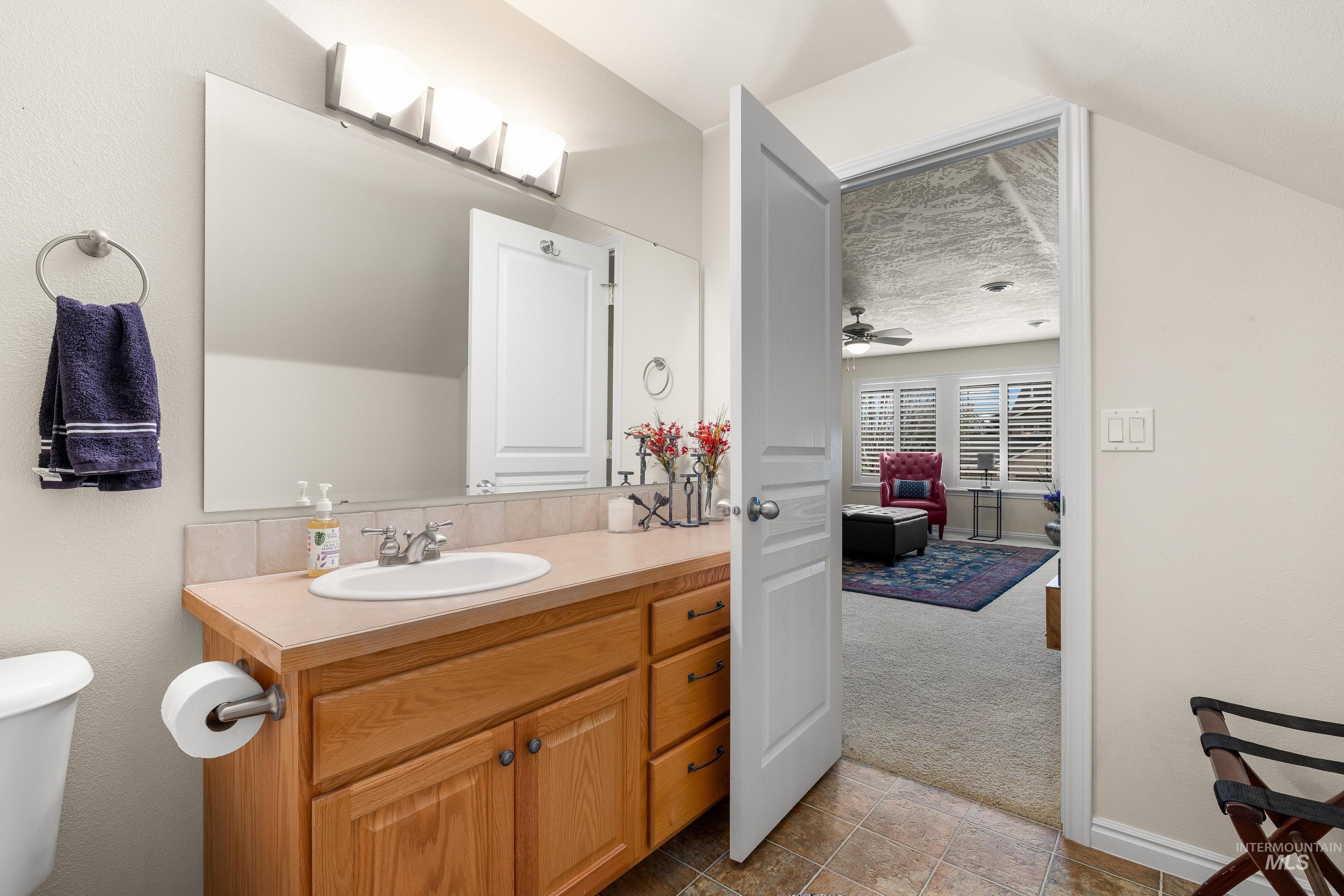 3631 North Alexis Way Meridian, ID 83646 - Photo 39 of 49 Bathroom with vanity, light colored carpet, and a textured ceiling