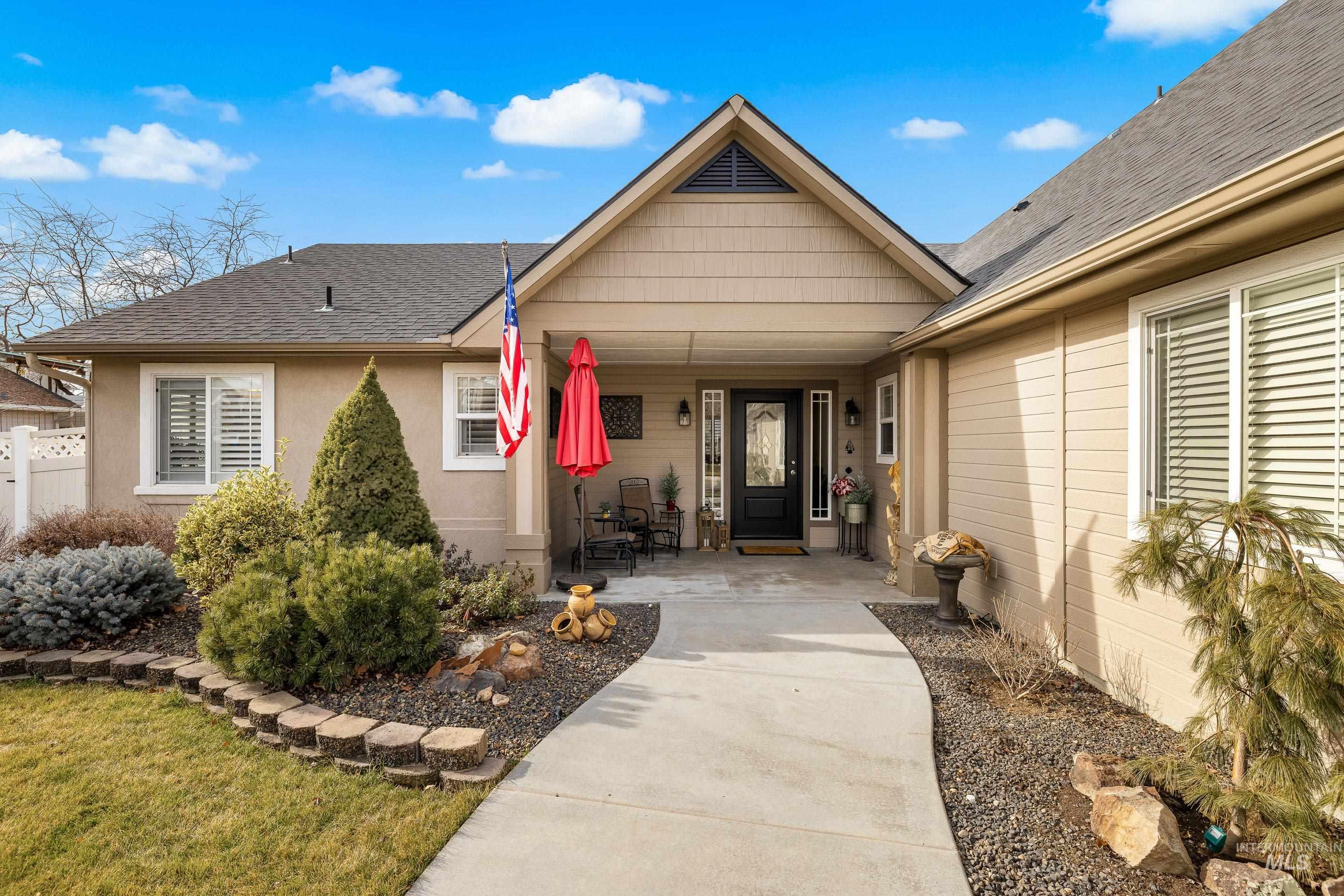 3631 North Alexis Way Meridian, ID 83646 - Photo 4 of 49 View of exterior entry featuring a shingled roof, covered porch, and stucco siding
