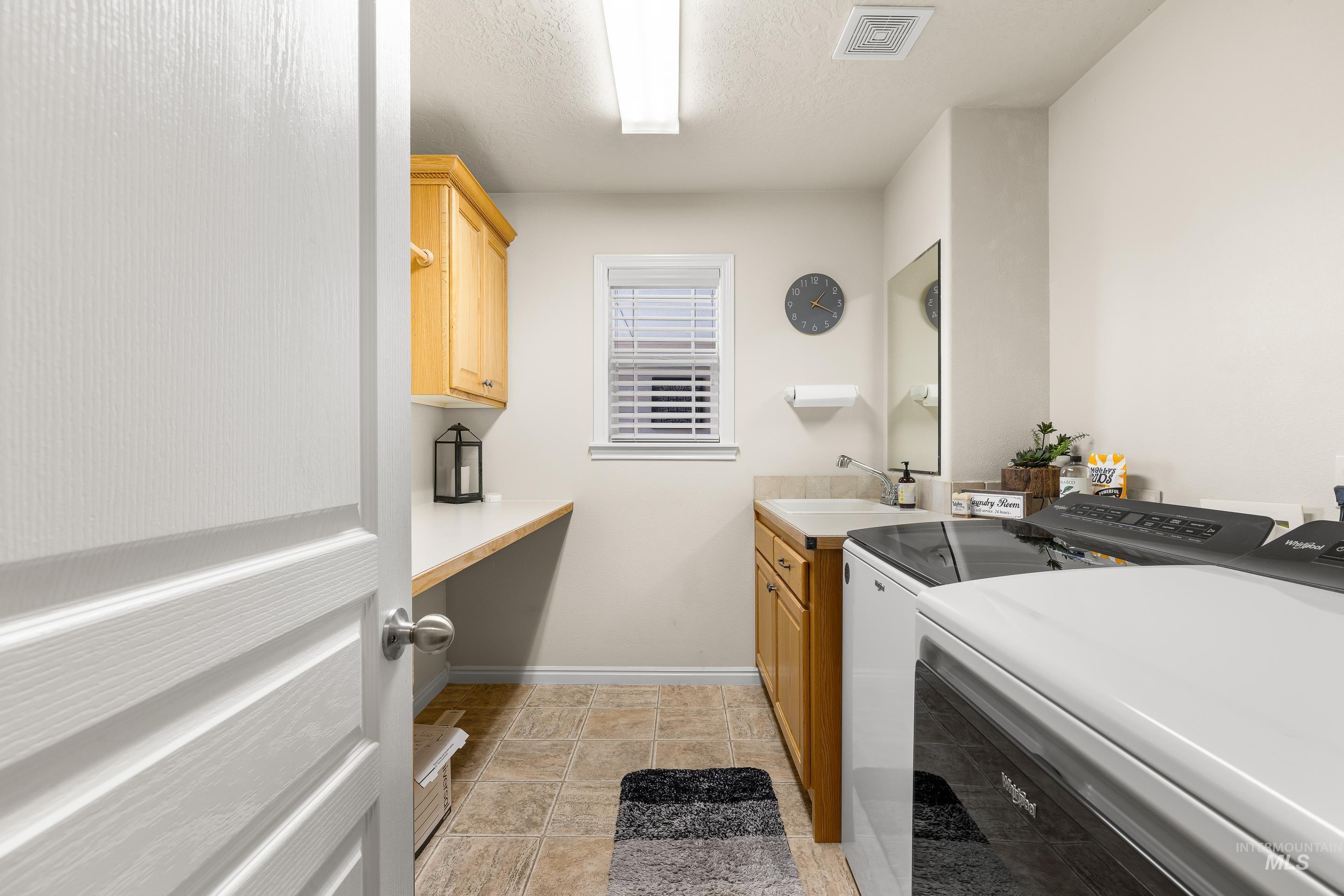 3631 North Alexis Way Meridian, ID 83646 - Photo 40 of 49 Laundry area with independent washer and dryer, cabinet space, and a textured ceiling