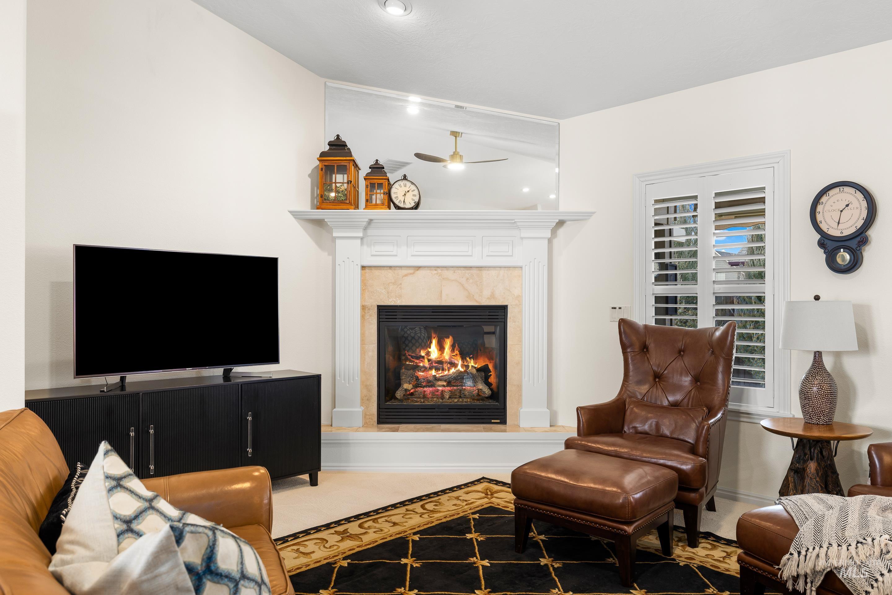 3631 North Alexis Way Meridian, ID 83646 - Photo 9 of 49 Living area with a premium fireplace, a ceiling fan, and carpet floors