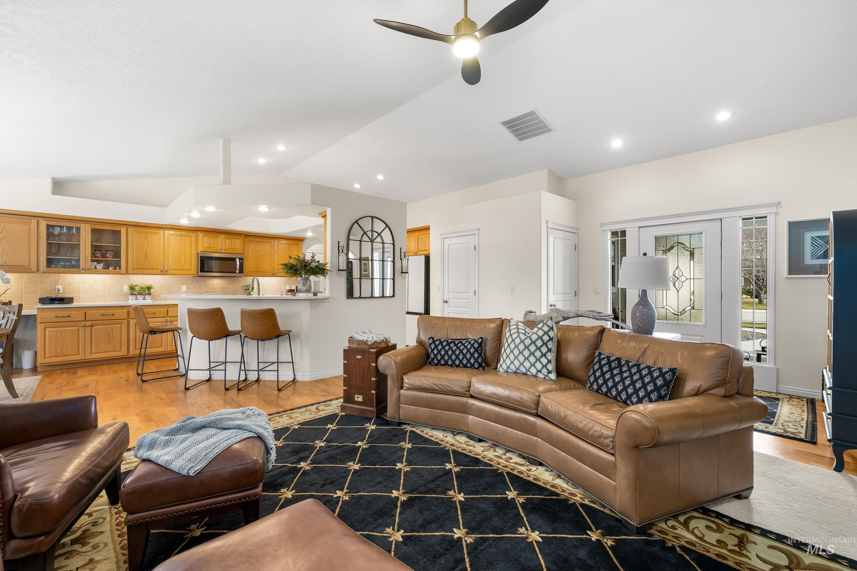 3631 North Alexis Way Meridian, ID 83646 - Photo 10 of 49 Living area featuring light wood-type flooring, lofted ceiling, a ceiling fan, and recessed lighting