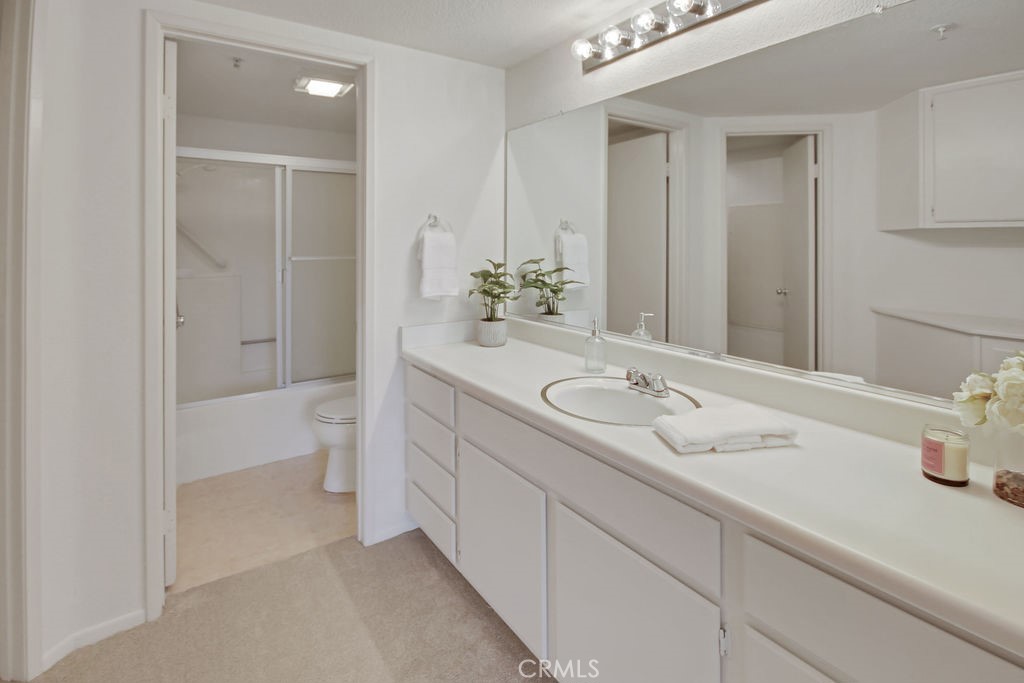 2800 Keller Drive, Unit 282 Tustin, CA 92782 - Photo 12 of 19 a spacious bathroom with a granite countertop sink and a mirror