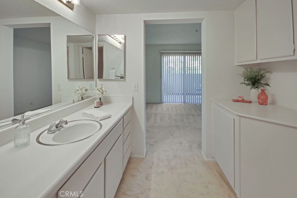 2800 Keller Drive, Unit 282 Tustin, CA 92782 - Photo 13 of 19 a en suite bathroom with a double vanity sink mirror and