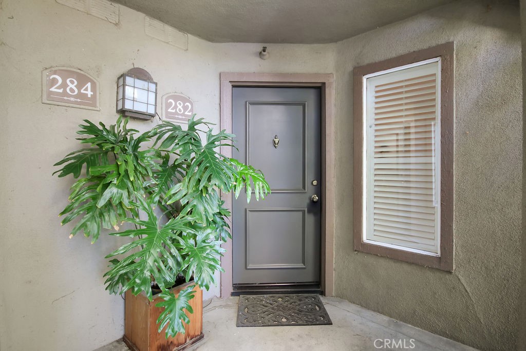 2800 Keller Drive, Unit 282 Tustin, CA 92782 - Photo 3 of 19 a vase of flowers sitting on a floor in front of a door