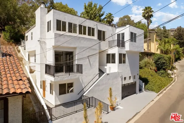 a view of a white building with large windows