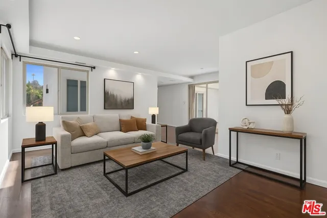 a living room with furniture and a mirror