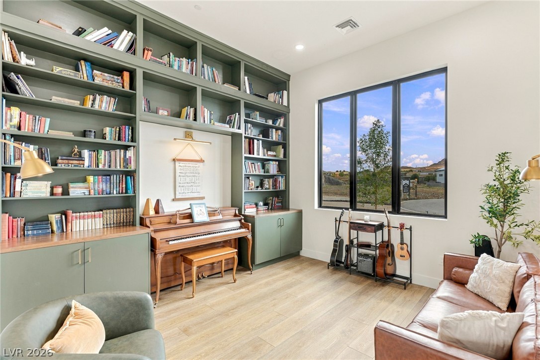 324 Wanda Road Henderson, NV 89002 - Photo 32 of 96 Massive floor-to-ceiling built-in bookcases and expansive picture windows define this versatile study.