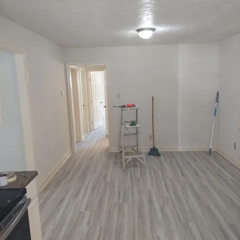 a view of wooden floor and chairs in a room