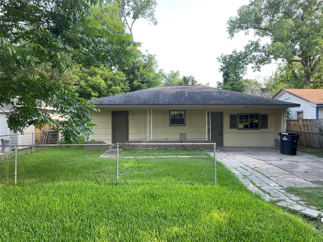 a view of a house with a yard and sitting area