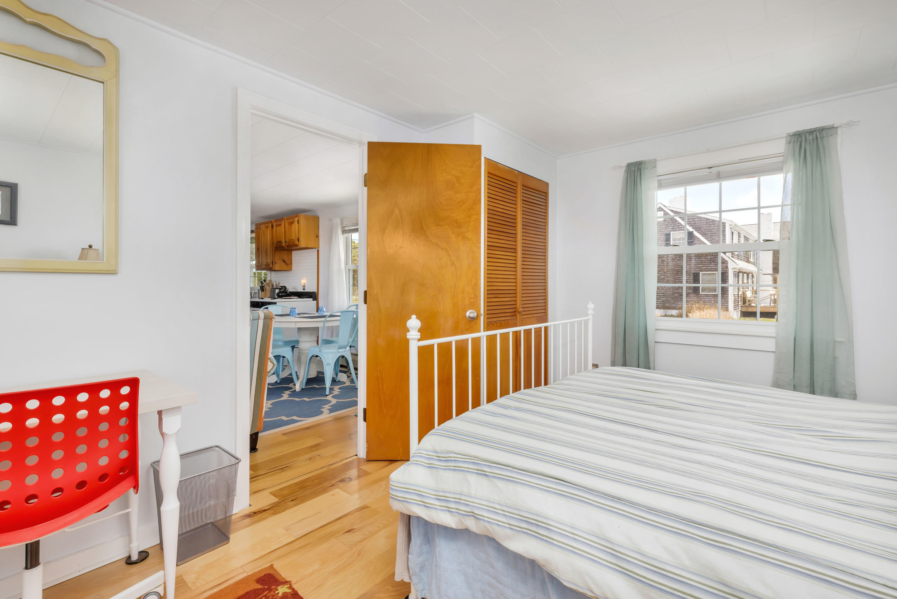 148 Shore Road, Unit 2 Truro, MA 02666 - Photo 14 of 16 a bedroom with a bed and a window