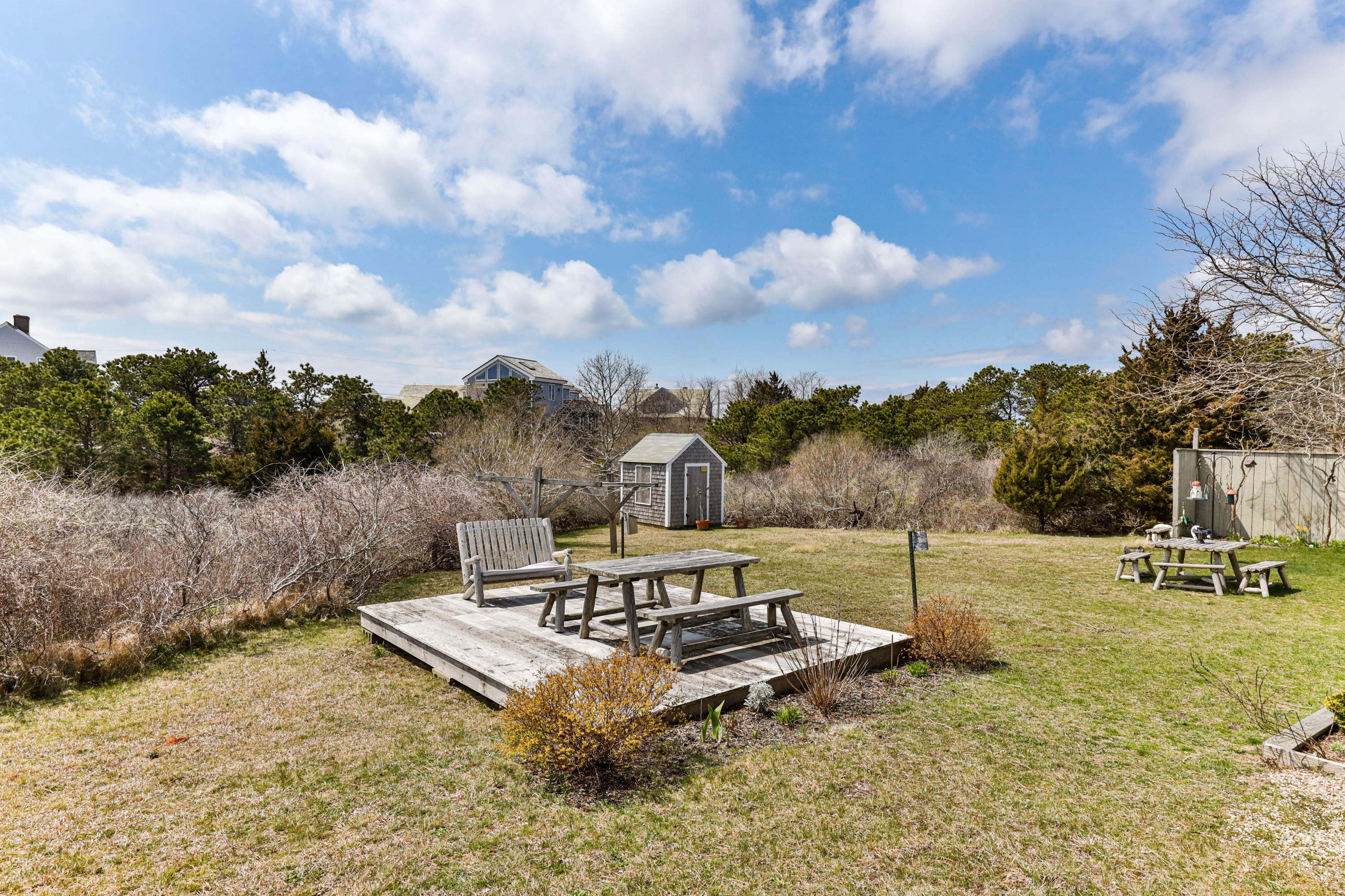 148 Shore Road, Unit 2 Truro, MA 02666 - Photo 15 of 16 a view of a fire pit with wooden fence