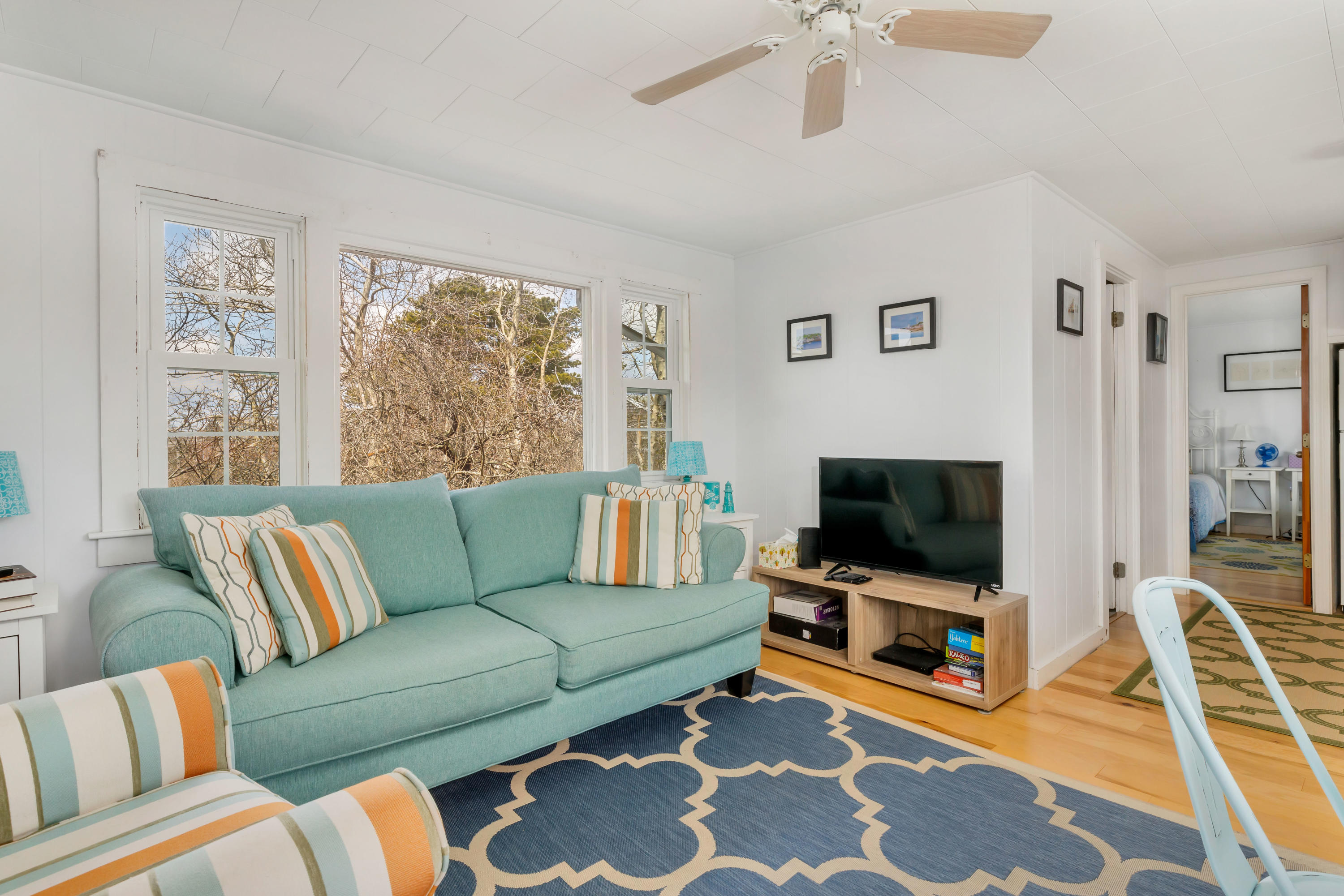 148 Shore Road, Unit 2 Truro, MA 02666 - Photo 4 of 16 a living room with furniture and a flat screen tv