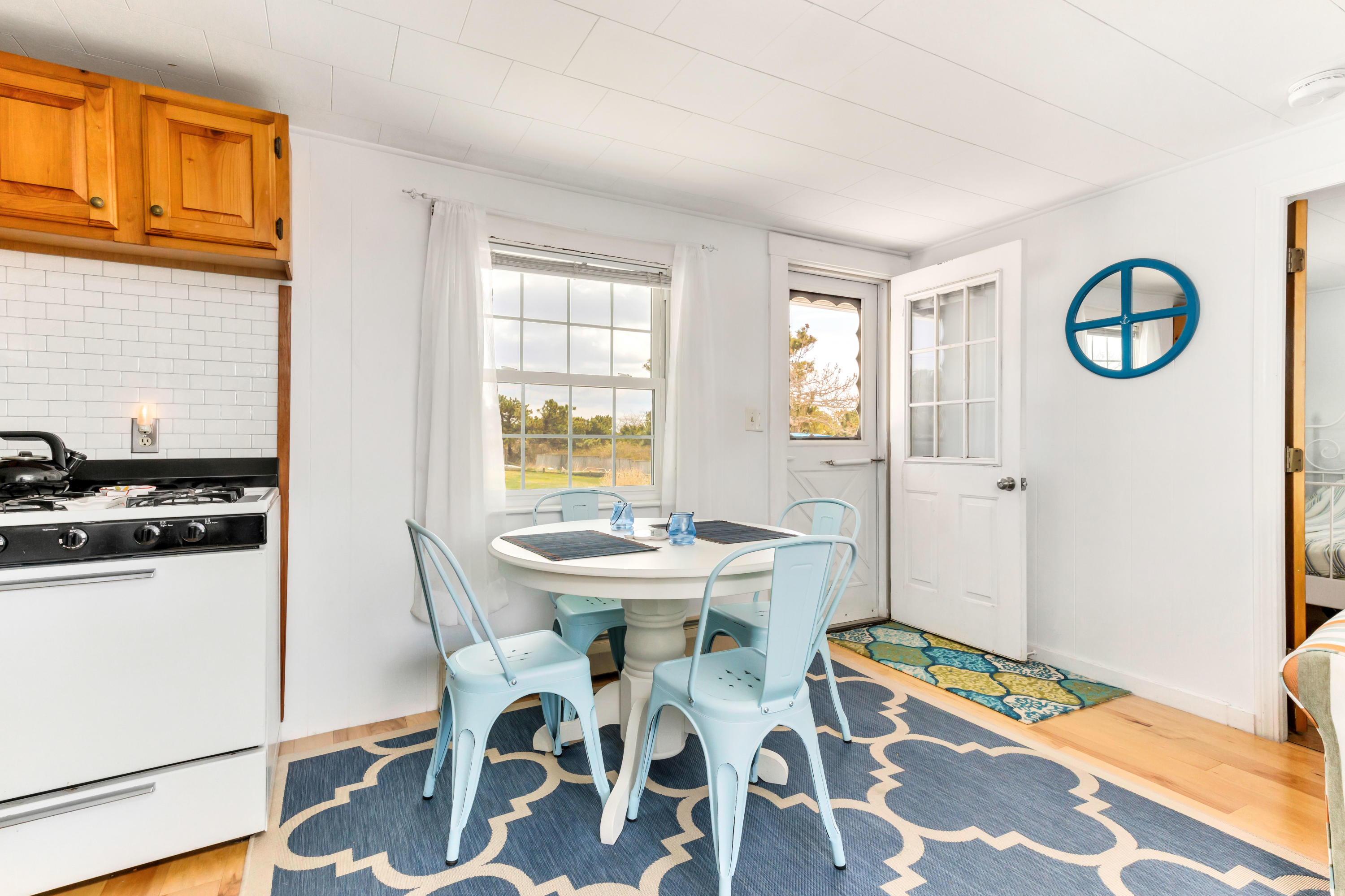 148 Shore Road, Unit 2 Truro, MA 02666 - Photo 6 of 16 a view of a dining room with furniture and a window