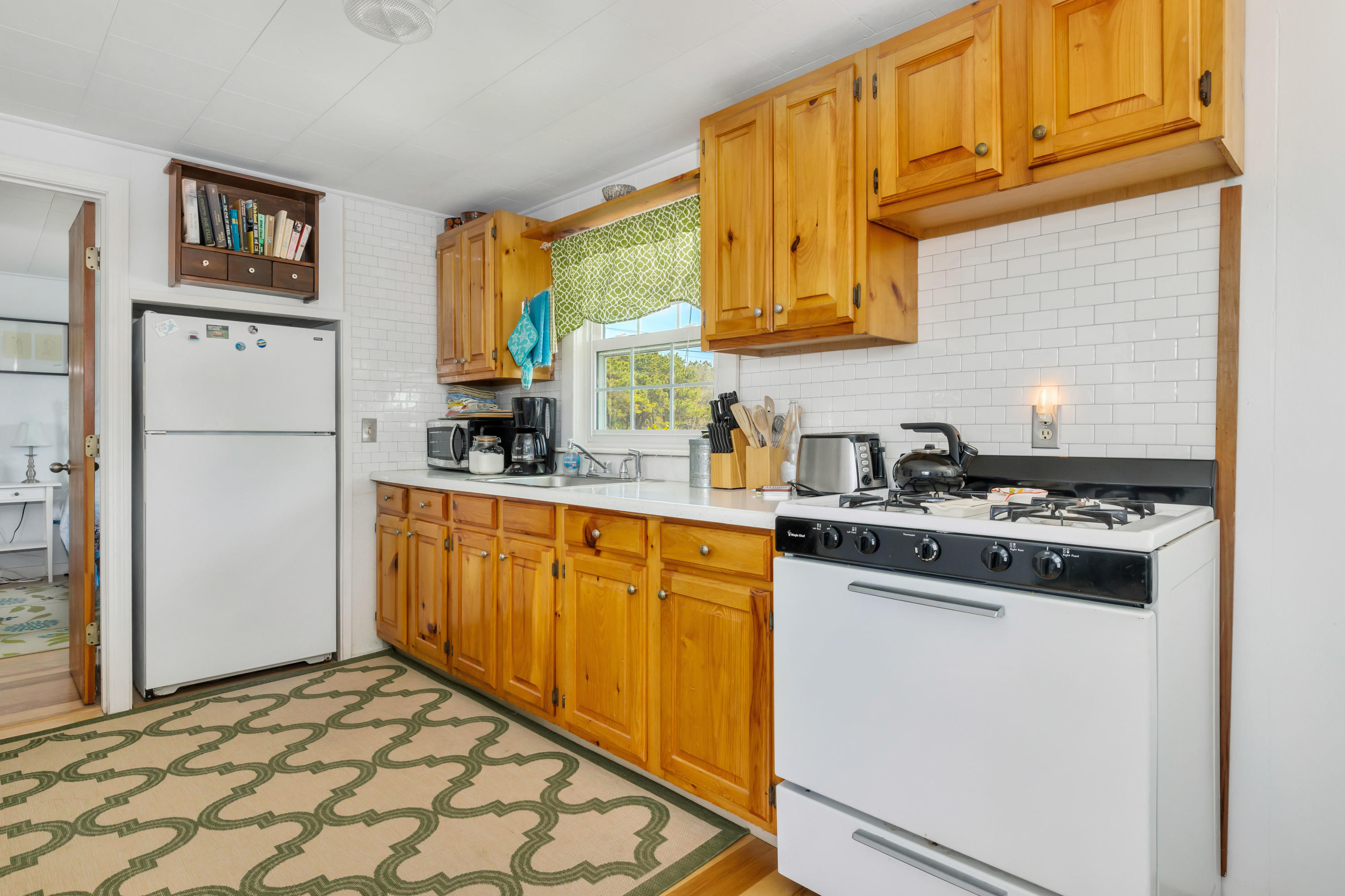 148 Shore Road, Unit 2 Truro, MA 02666 - Photo 7 of 16 a kitchen with stainless steel appliances granite countertop a refrigerator stove top oven and sink