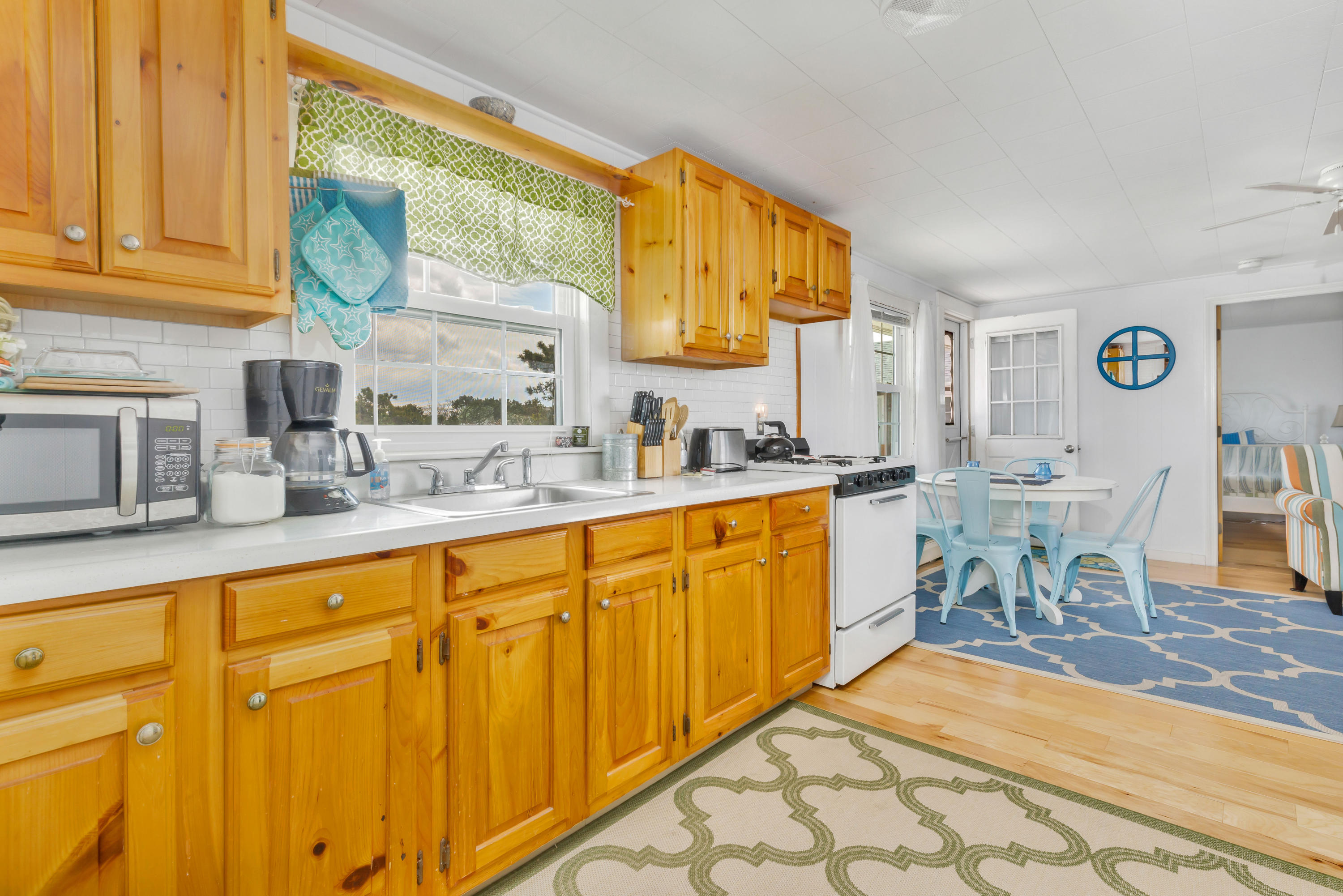 148 Shore Road, Unit 2 Truro, MA 02666 - Photo 8 of 16 a kitchen with stainless steel appliances a sink and cabinets