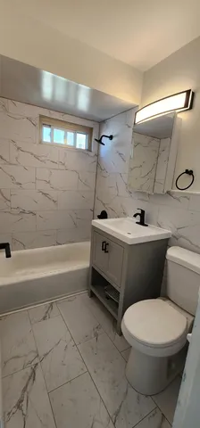 a bathroom with a sink a toilet and bathtub
