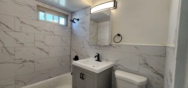 a bathroom with a sink toilet and shower