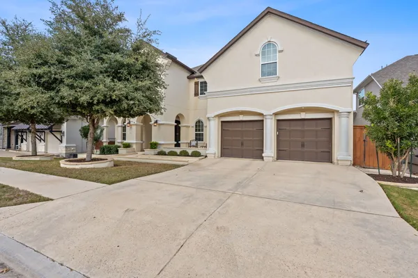 a view of garage with a white fence