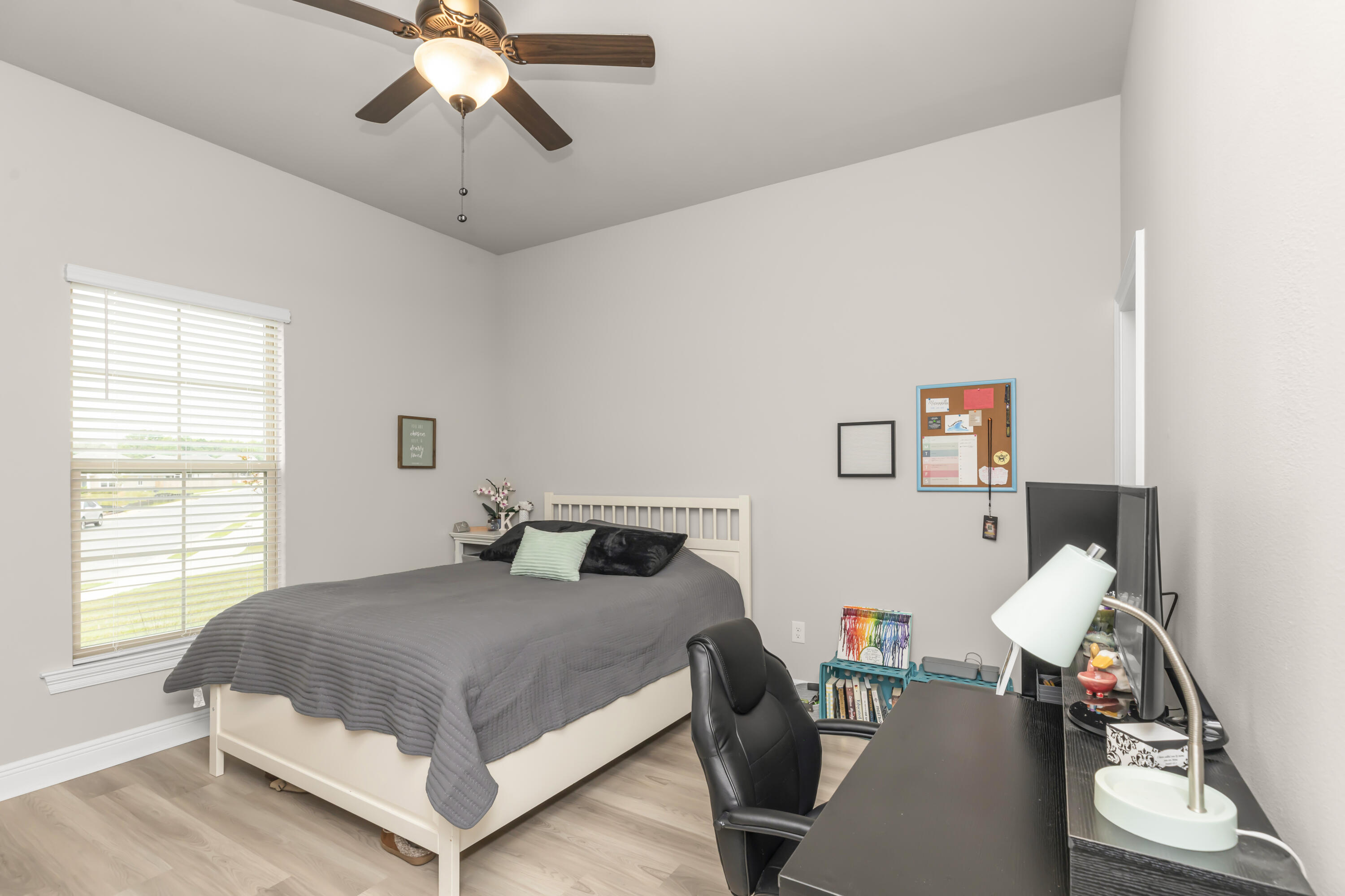 4729 Sago Palm Circle Pace, FL 32571 - Photo 12 of 29 a bedroom with a bed and a chandelier