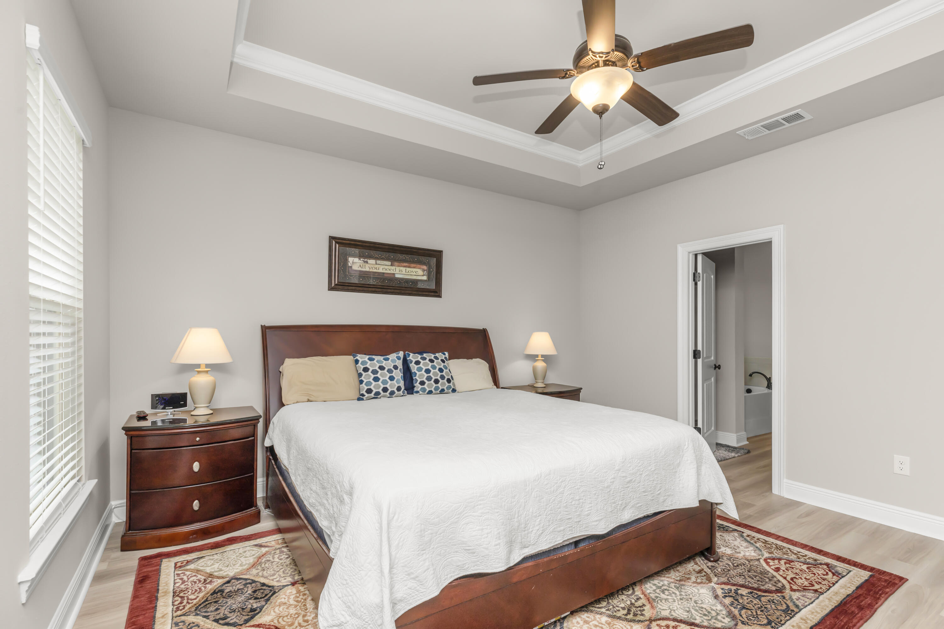 4729 Sago Palm Circle Pace, FL 32571 - Photo 17 of 29 a bedroom with a bed and a chandelier