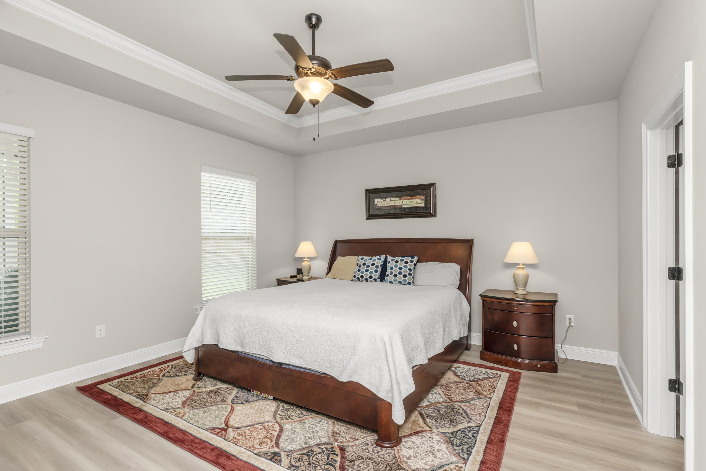 4729 Sago Palm Circle Pace, FL 32571 - Photo 18 of 29 a bedroom with a large bed and a chandelier