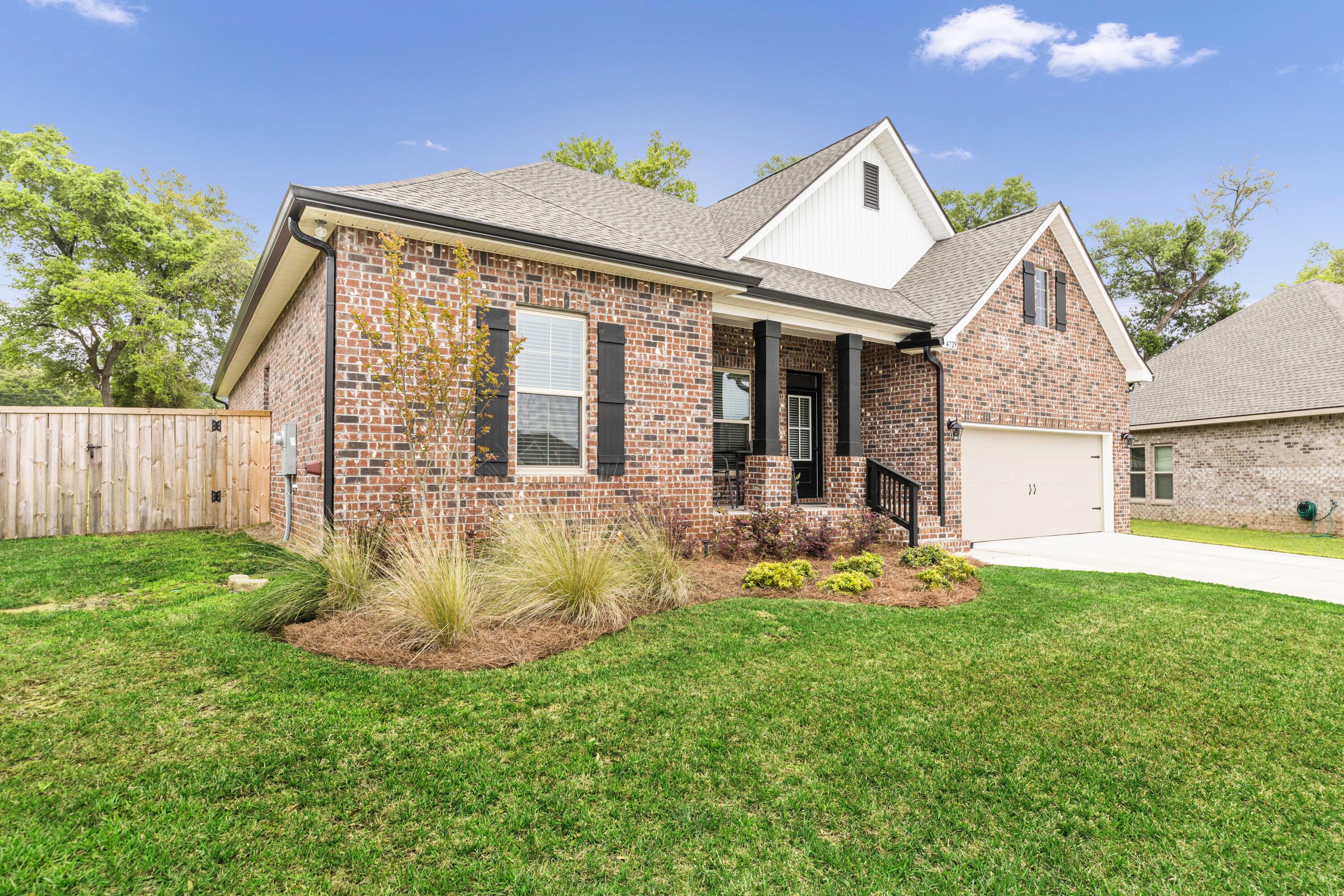 4729 Sago Palm Circle Pace, FL 32571 - Photo 2 of 29 a front view of a house with a yard and porch