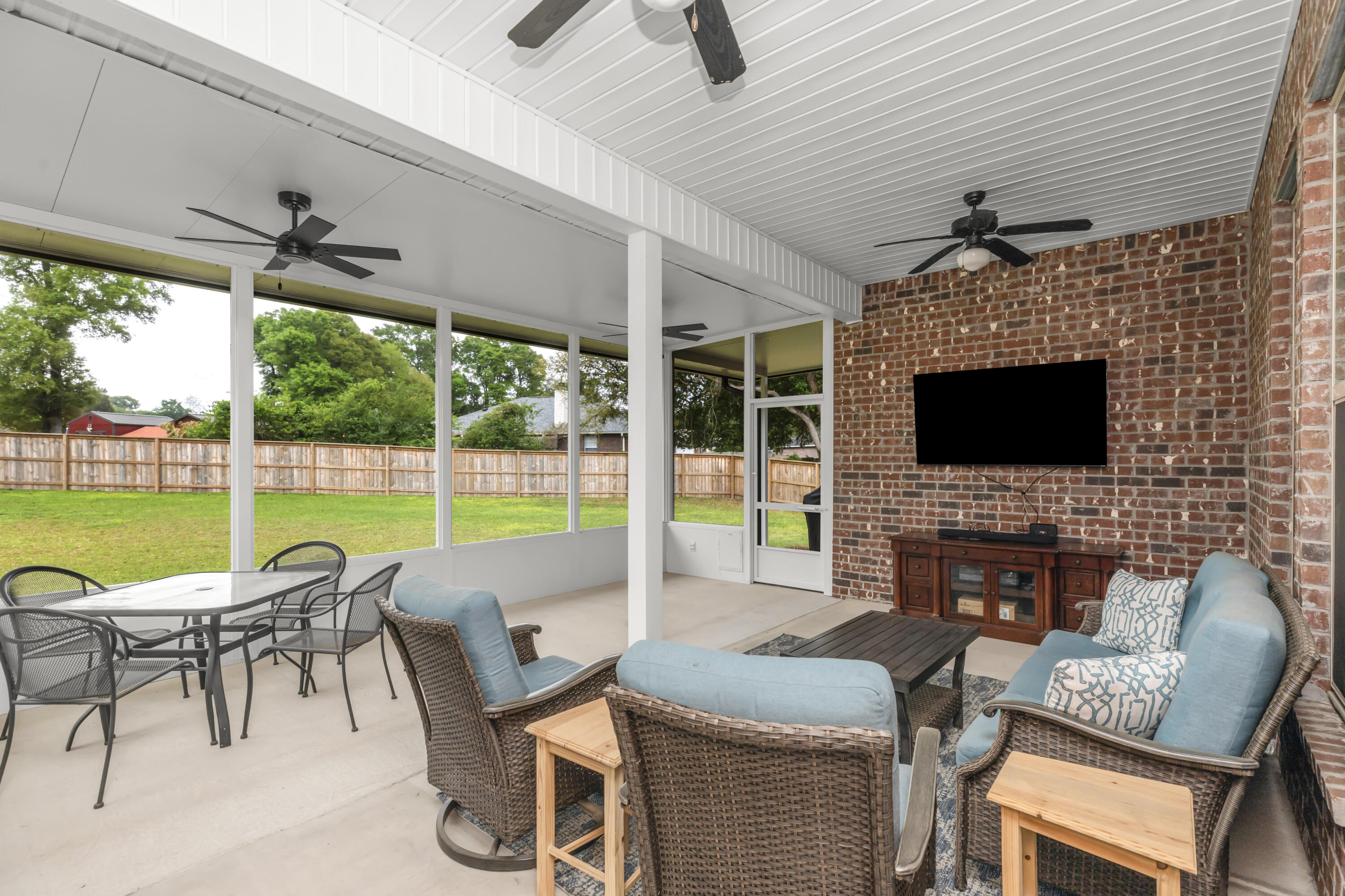 4729 Sago Palm Circle Pace, FL 32571 - Photo 25 of 29 a outdoor space with patio the couches and a flat screen tv