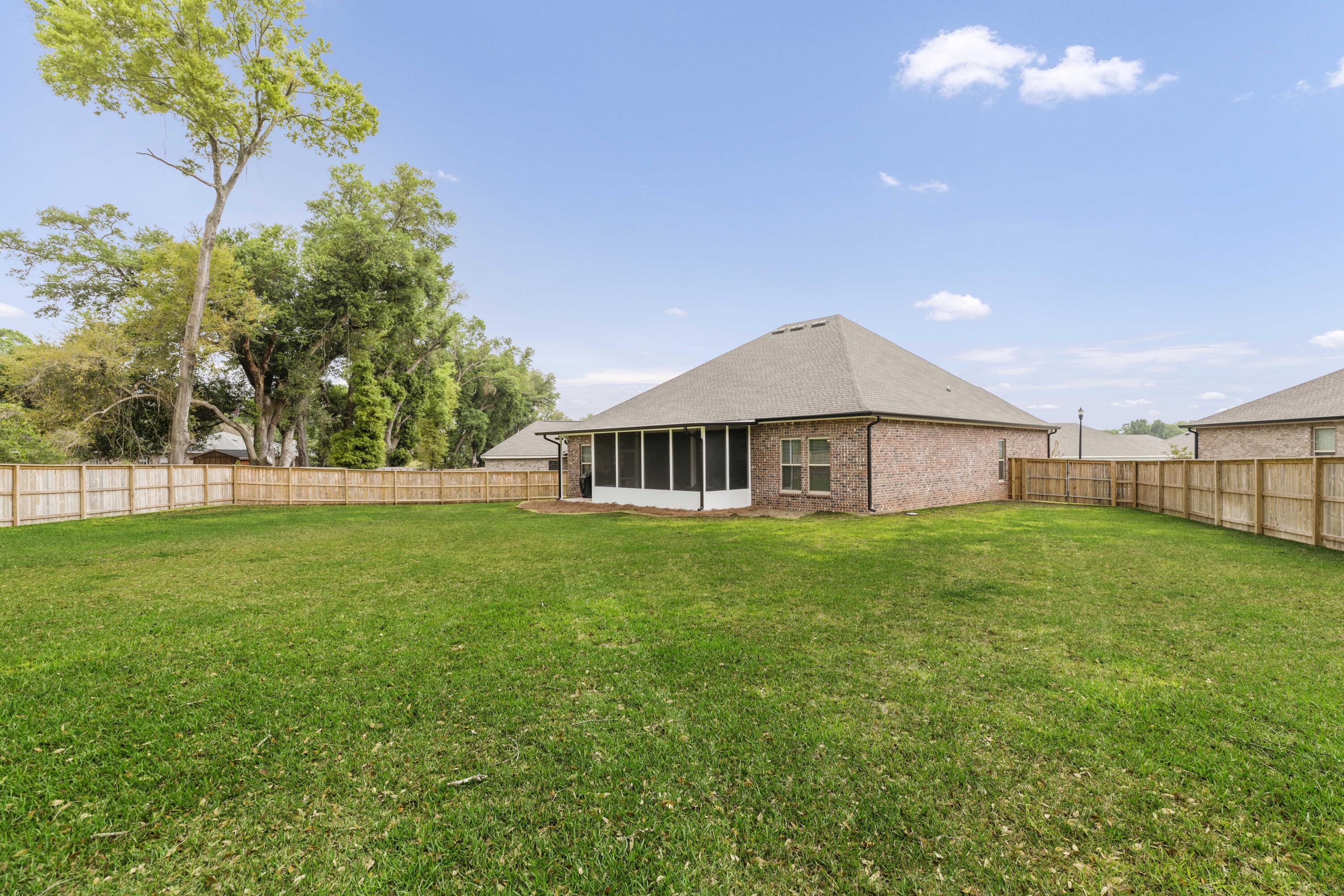 4729 Sago Palm Circle Pace, FL 32571 - Photo 28 of 29 a view of a house with a big yard