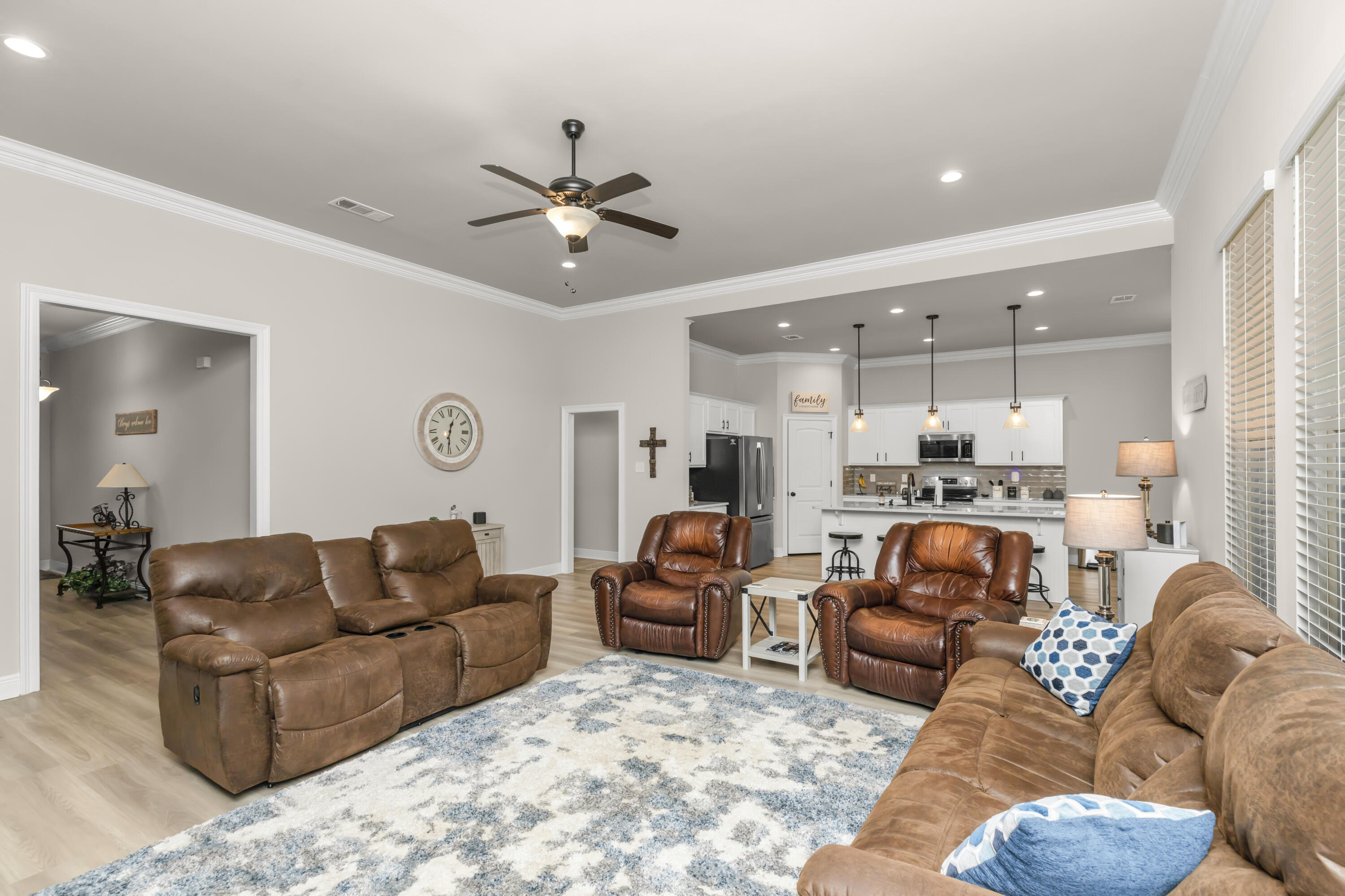 4729 Sago Palm Circle Pace, FL 32571 - Photo 6 of 29 a living room with furniture kitchen view and a chandelier