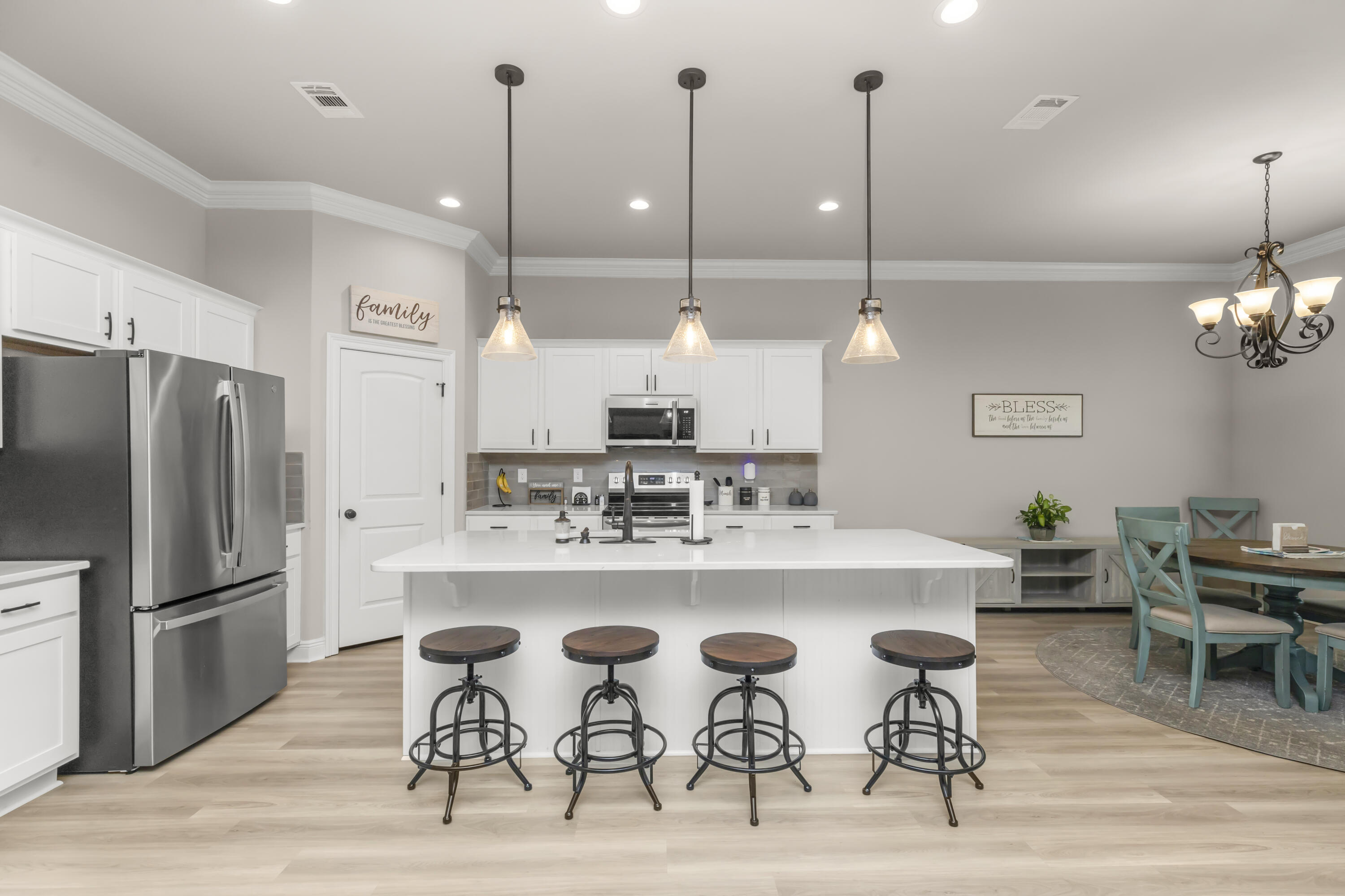 4729 Sago Palm Circle Pace, FL 32571 - Photo 7 of 29 a kitchen with cabinets and wooden floor