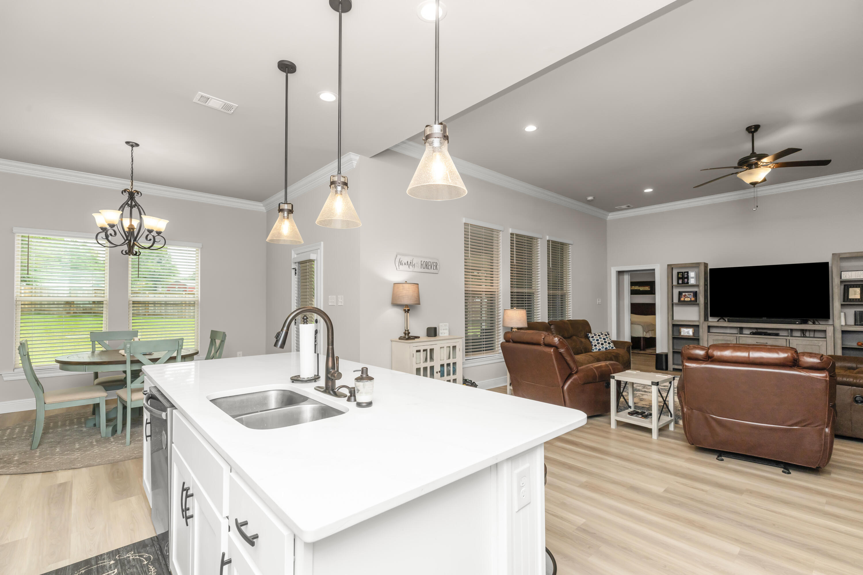 4729 Sago Palm Circle Pace, FL 32571 - Photo 9 of 29 a living room with furniture a flat screen tv and kitchen view