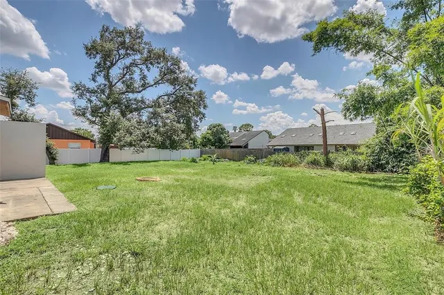 a green field with lots of tress in it