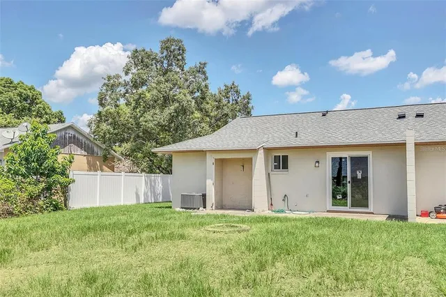 a view of a house with a backyard