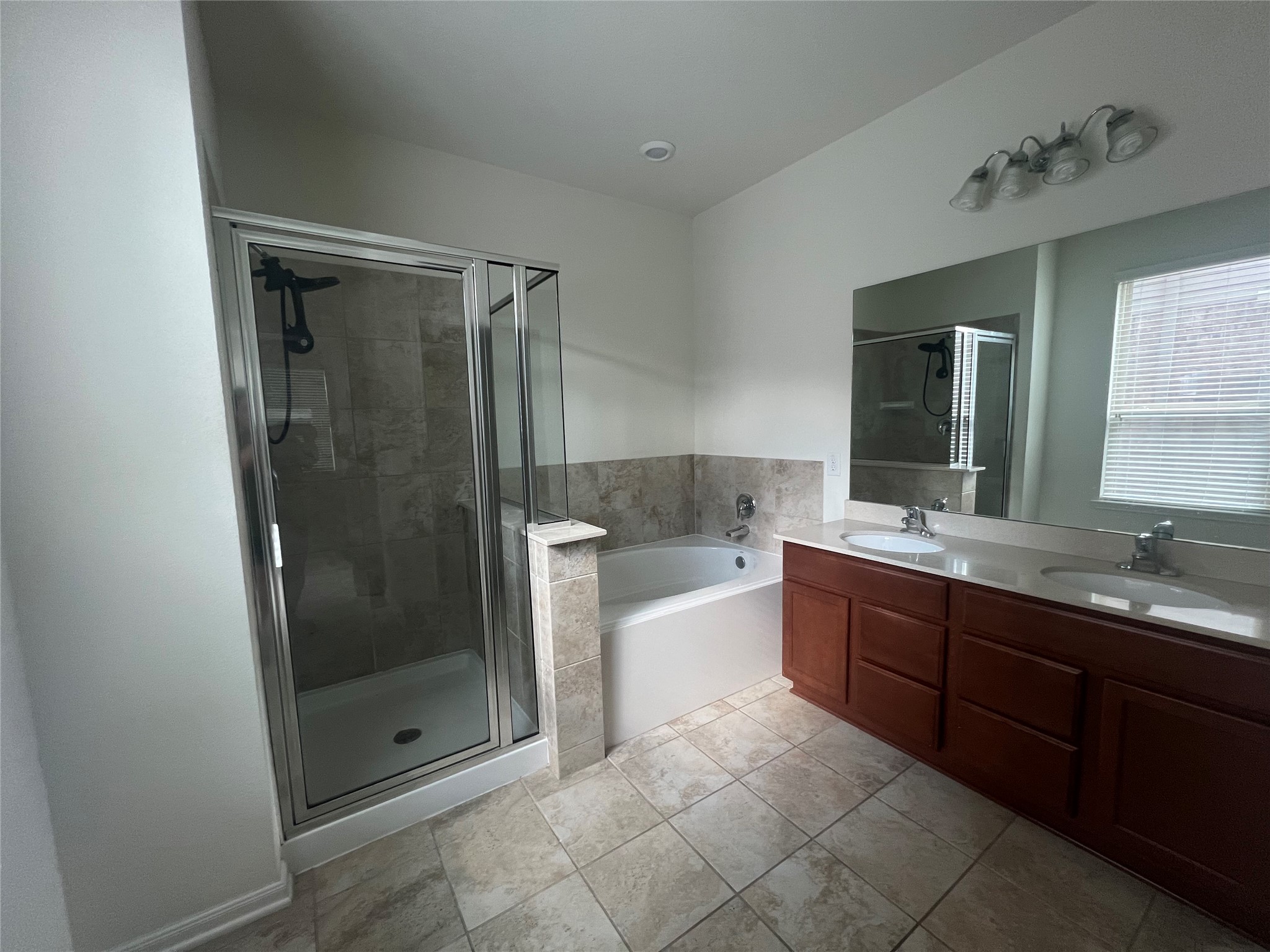 14112 Harmony Ridge Trail Pearland, TX 77584 - Photo 14 of 45 a bathroom with a bathtub shower sink and mirror