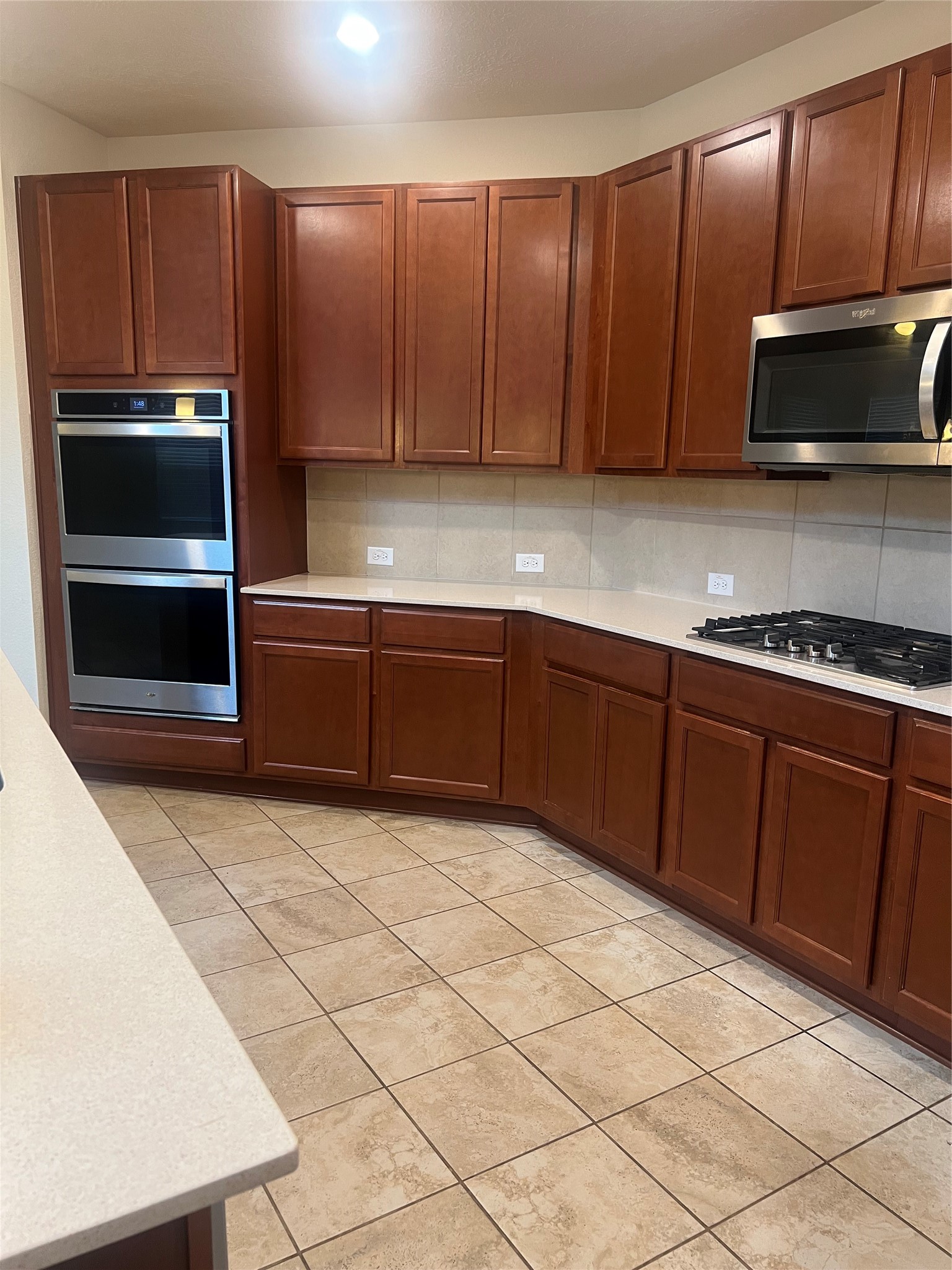 14112 Harmony Ridge Trail Pearland, TX 77584 - Photo 16 of 45 a kitchen with stainless steel appliances a stove a microwave and sink